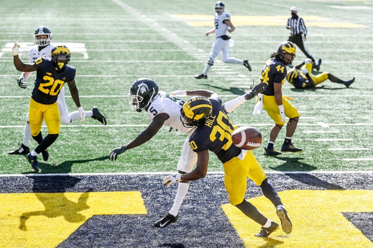 Michigan's Daxton Hill, right, breaks up a pass intended for Michigan State's Jayden Reed, left, during the second quarter on Saturday, Oct. 31, 2020, at Michigan Stadium in Ann Arbor. 201031 Msu Um 077a Dax Hill